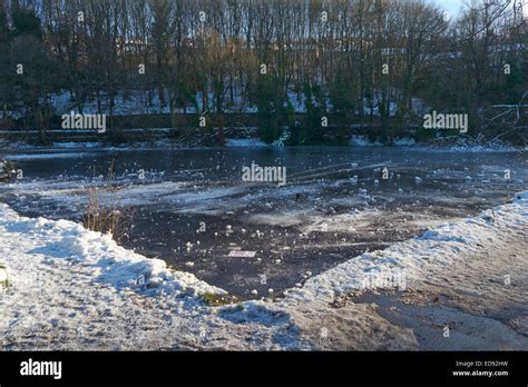 Icy Frozen Pond In The Rivelin Valley Sheffield England Uk Stock