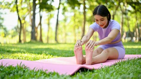 healthy asian woman in sportswear stretching her legs and arms on yoga mat stock image image
