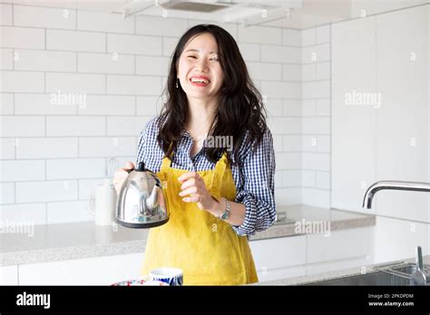 Woman Wearing Apron In Kitchen Hi Res Stock Photography And Images Alamy