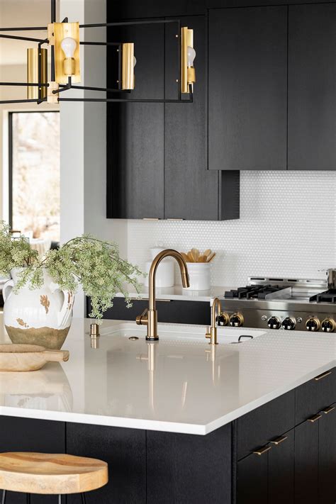 In this attractive design, black and white striped walls are framing gilt mirror hanged over bold black makeup vanity topped with contrasting white top; White Quartz Kitchen Island with Gold Hardware | Modern ...