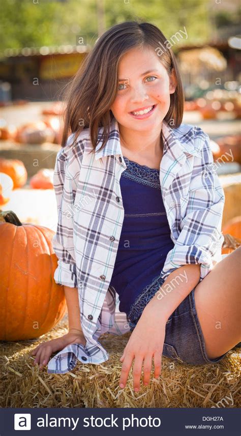 Preteen Girl Portrait At The Pumpkin Patch In A Rustic