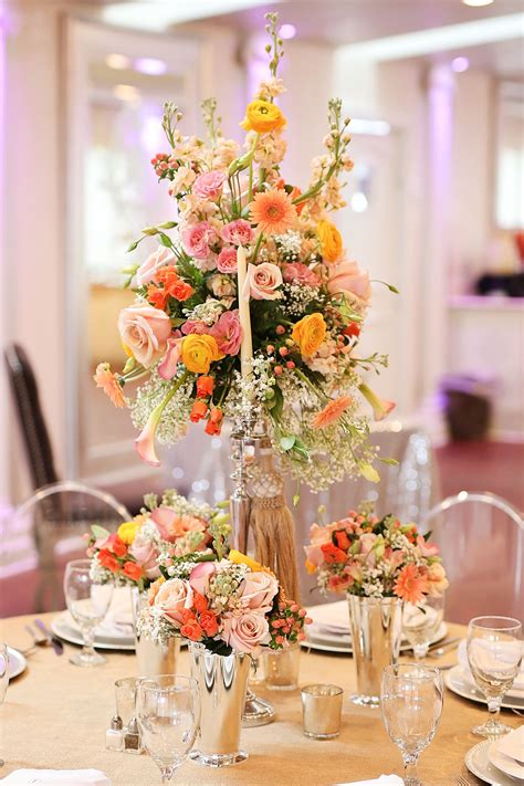 Reception flowers continue the theme of your wedding, and provide focal points, directing guests to different areas of the reception area. Tall wedding reception floral centerpiece with peach ...