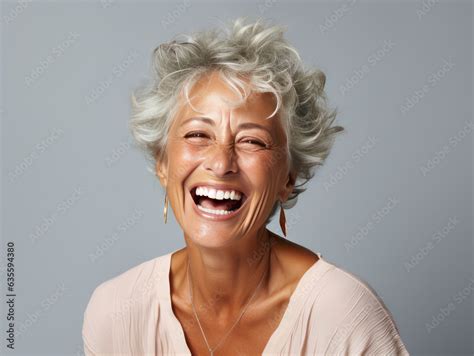 beautiful gorgeous 50s mid age beautiful elderly senior model woman with grey hair laughing and