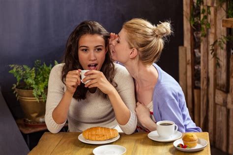 premium photo woman telling secret to her friend
