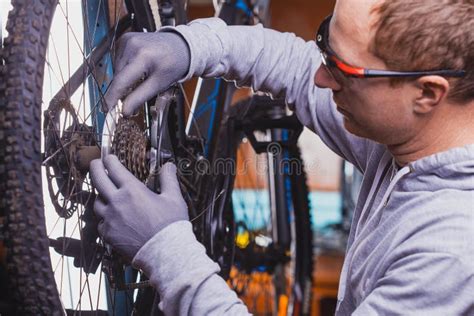 Bike Mechanic Repairs Bicycle In Workshop Stock Photo Image Of Retail