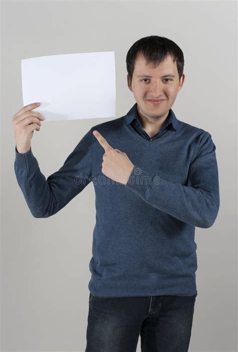 A Young Man Holds A White Sheet Of Paper Stock Image Image Of Showing