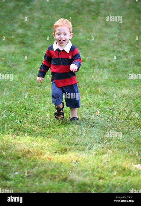 Happy Boy Running Down Hill Stock Photo Alamy