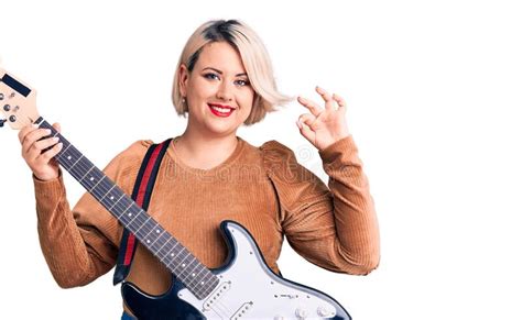 Young Blonde Plus Size Woman Playing Electric Guitar Doing Ok Sign With