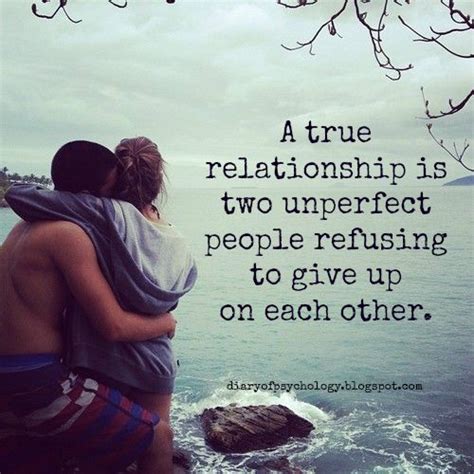 two people hugging each other on the shore with an ocean in the background and a quote written below