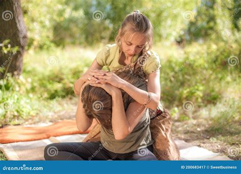 Woman Masseuse Provides A Thorough Massage On The Forest Floor Stock