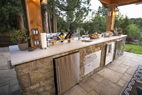 An Outdoor Kitchen With Stainless Steel Appliances