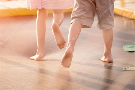 Childrens Legs Running On The Trampoline Stock Photo By ©photozaur