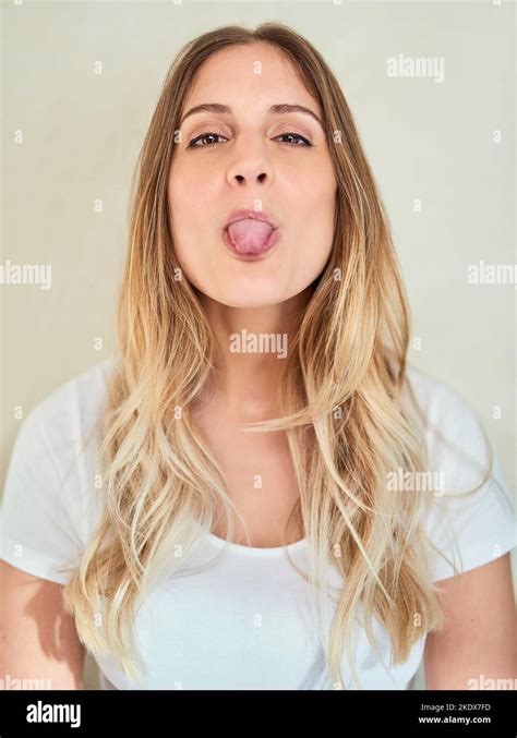 Shes Got A Cheeky Side To Show Portrait Of An Attractive Young Woman Sticking Out Her Tongue