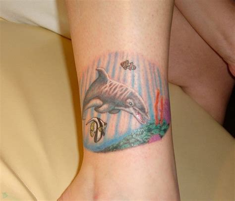 Simple Tiny Colored Dolphin Tattoo On Ankle Tattooimagesbiz