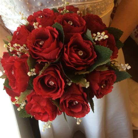 A Brides Wedding Bouquet Featuring Artificial Silk Red Roses