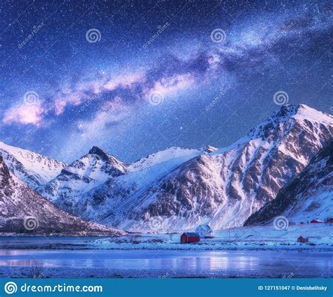 Milky Way Above Houses And Snow Covered Mountains In