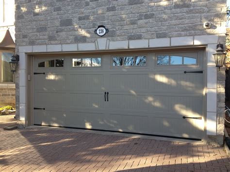 Haas 664 Carriage Door In Sandstone With Arched Windows And Wrought Iron Decorative Hardware