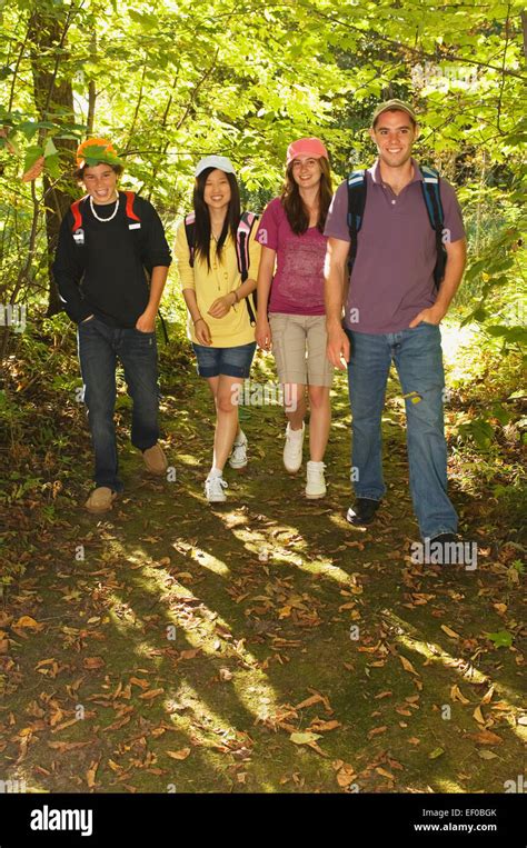 Friends Walking On A Forest Trail Stock Photo Alamy