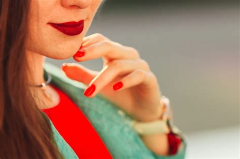 Premium Photo Stylish Girl With Red Lips Closeup Holds Her Hand