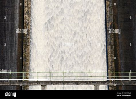 Water Flowing Over High Steep Concrete Dam Spillway At Thruscross