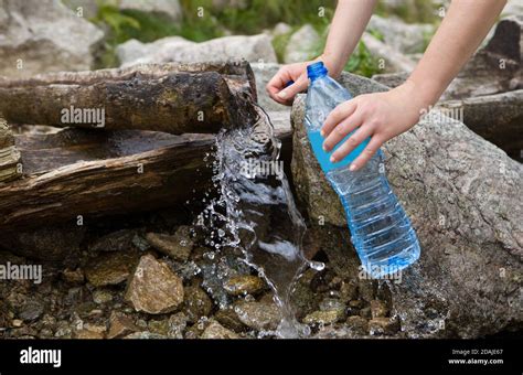 Taking Spring Water From A Mountain Spring Plastic Bottle Water