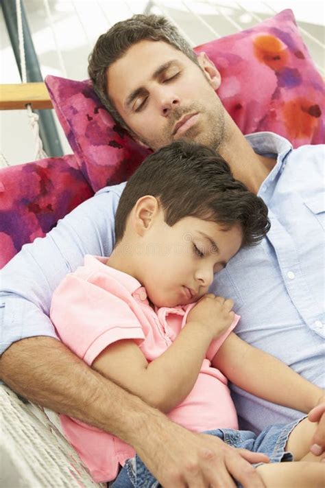 Father And Son Sleeping In Garden Hammock Together Stock Photo Image