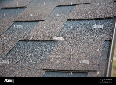 A Close Up On Architectural Asphalt Shingles Installed On A Roof Brown