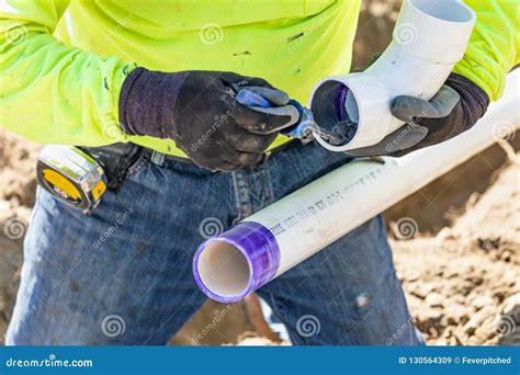 Plumber Applying Pipe Cleaner Primer And Glue To Pvc Pipes Royalty Free Stock Image