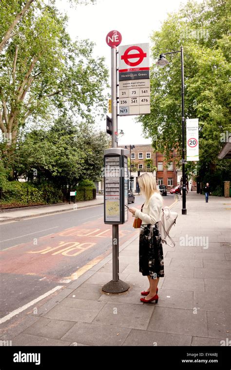 London Bus Stop A Woman Waiting For A Bus At A Bus Stop Newington