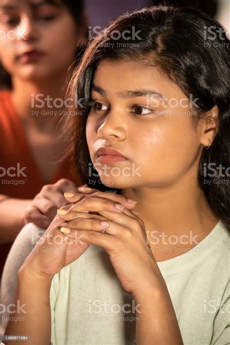 Young Woman Consoling And Comforting Her Female Friend Stock Photo