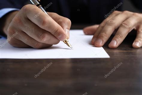 Man Signing A Document Or Writing Correspondence With A Close Up View