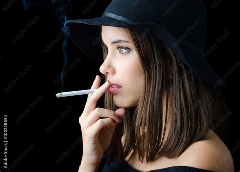 Portrait Of The Beautiful Elegant Girl Smoking Cigarette Stock Photo