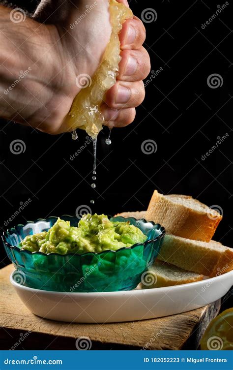 Hand Squeezing A Lemon In A Mexican Guacamole Dip Stock Image Image