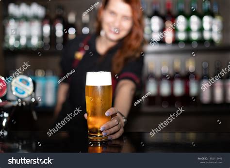 Portrait Attractive Female Bartender Tapping Beer Stock Photo