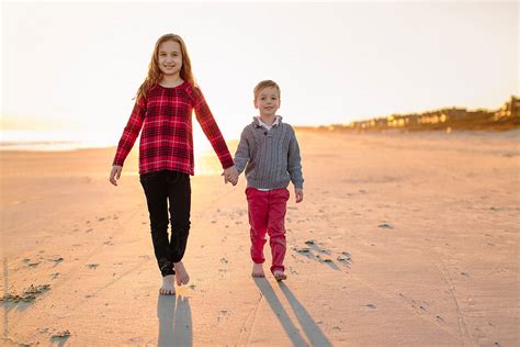 Brother And Sister Walking On A Beach Together By Stocksy Contributor