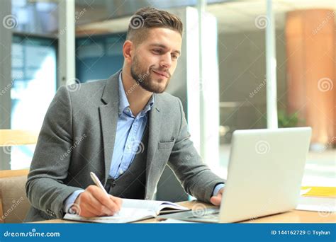 Portrait Of Young Man Sitting At His Desk In The Office Stock Image