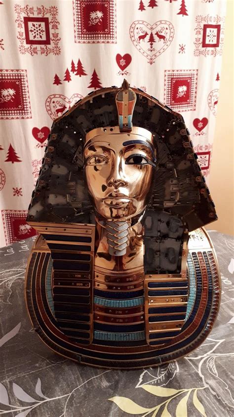 An Egyptian Mask Made Out Of Cardboard On Top Of A Table