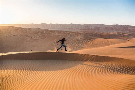 Man Running Alone In The Desert By Stocksy Contributor Mauro