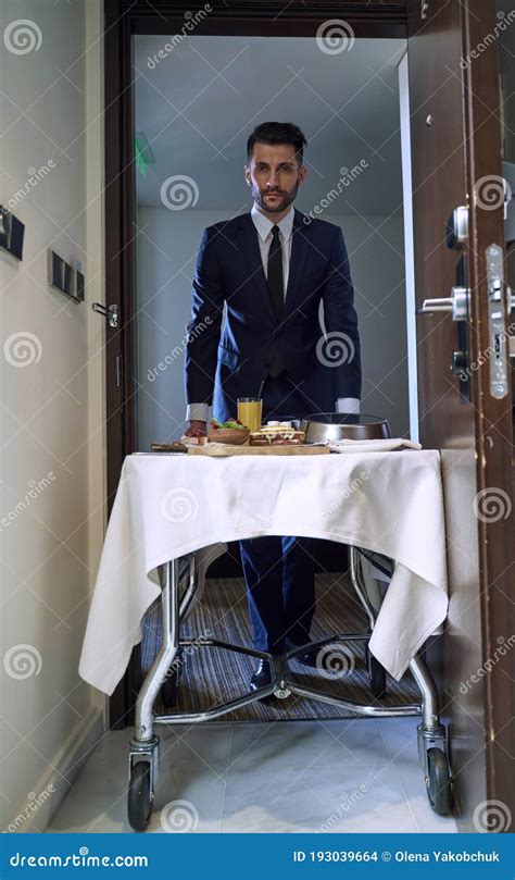 Caucasian Room Service Waiter Serving Food In Room Stock Photo Image