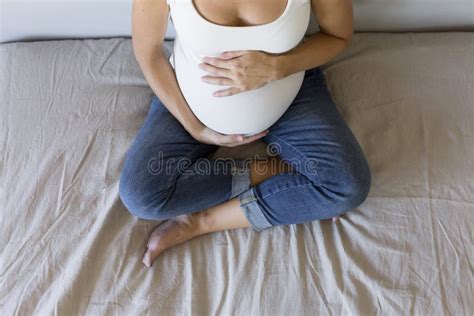 Attractive Pregnant Woman Is Sitting In Bed Holding Her Belly And Smiling Last Months Of