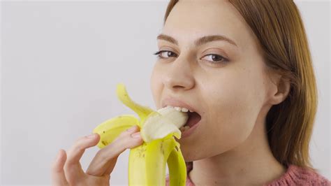 close up portrait of woman eating banana eat fruit close up of woman eating banana 21568030