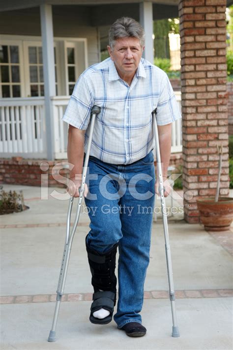 Mature Man On Crutches Stock Photo Royalty Free Freeimages