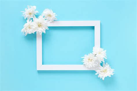 Una piccola cornice a forma di fiore, da regalare per un compleanno, una festa come la festa della mamma, la festa dei nonni o semplicemente per fare piacere ad una persona cara. Vista dell'angolo alto dei fiori bianchi e della cornice ...