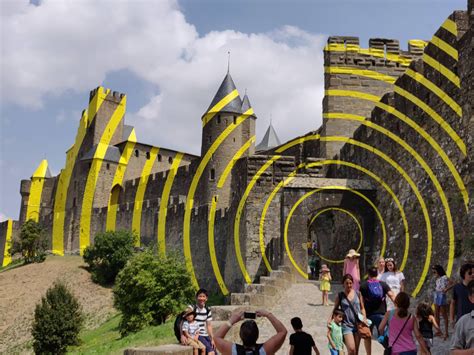 The tile might feature a city, a road, a cloister, grassland or some combination thereof, and it must be placed adjacent to tiles that have already been played, in such a. Yellow rings painted on Carcassonne Castle, France ...