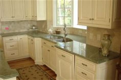 Light green kitchen cabinets with black countertops. The Best Paint Colours to Update Forest Green | Home ...