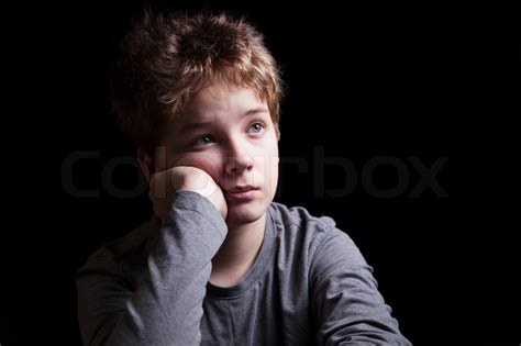 Portrait Sad Teenage Boy On A Black Background Stock