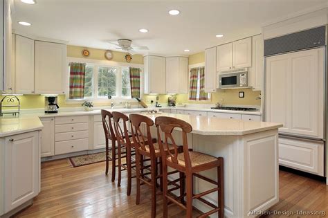 From urban modern to this bright and beautiful country style kitchen by crown point cabinetry features traditional yellow kitchen cabinets and a contrasting wood island. Pictures of Kitchens - Traditional - White Kitchen ...