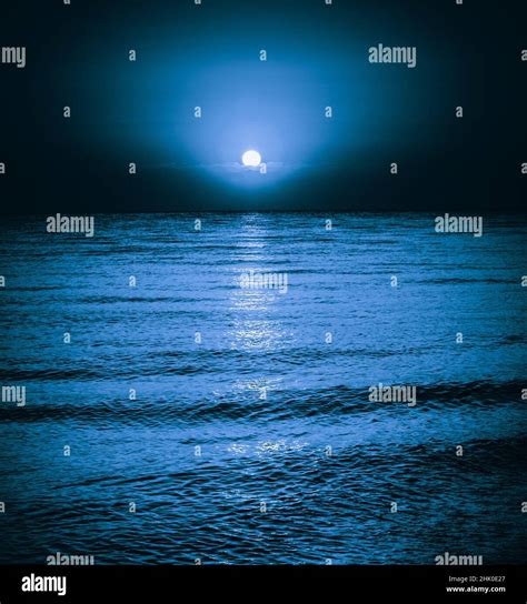 Moon Reflecting In A Lake Sea Ocean Waves Moonlight Night Background Stock Photo Alamy