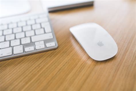 White Apple Mouse And Keyboard On A Wooden Desk · Free Stock Photo