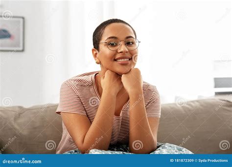 african american woman in glasses sitting on sofa stock image image of eyeglasses home 181872309